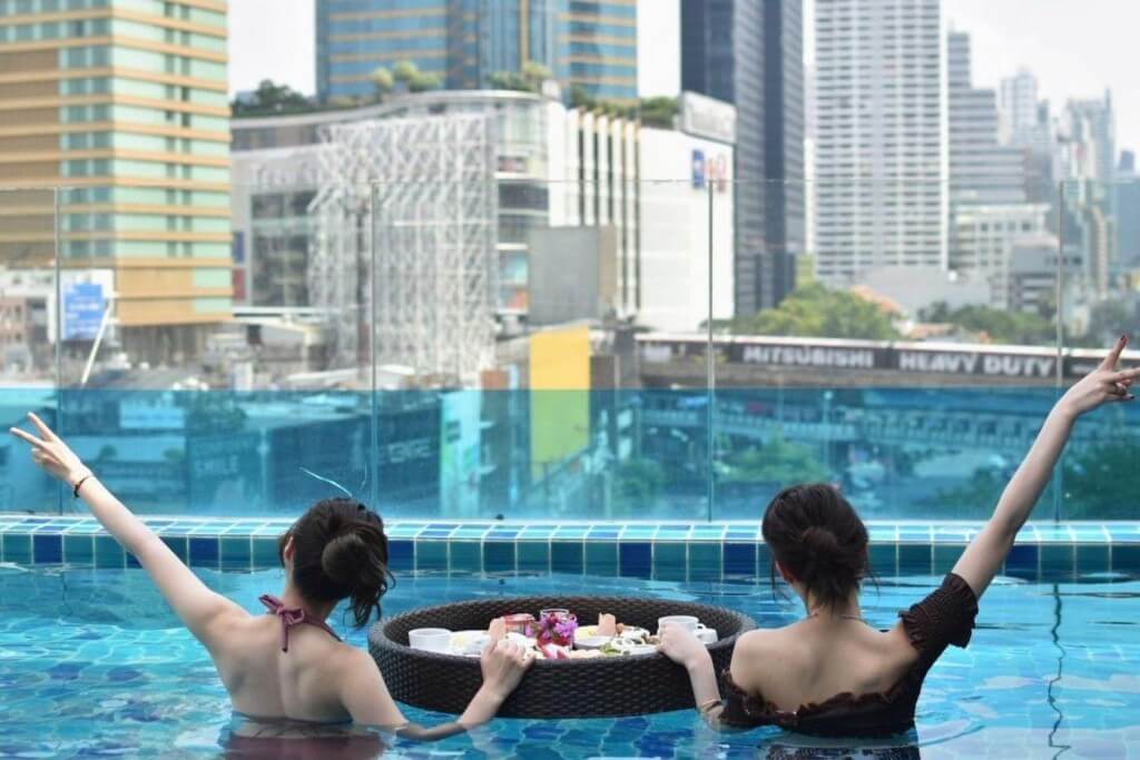 The rooftop pool at Hotel Clover Asoke offers a relaxing atmosphere with views of the Bangkok cityscape.