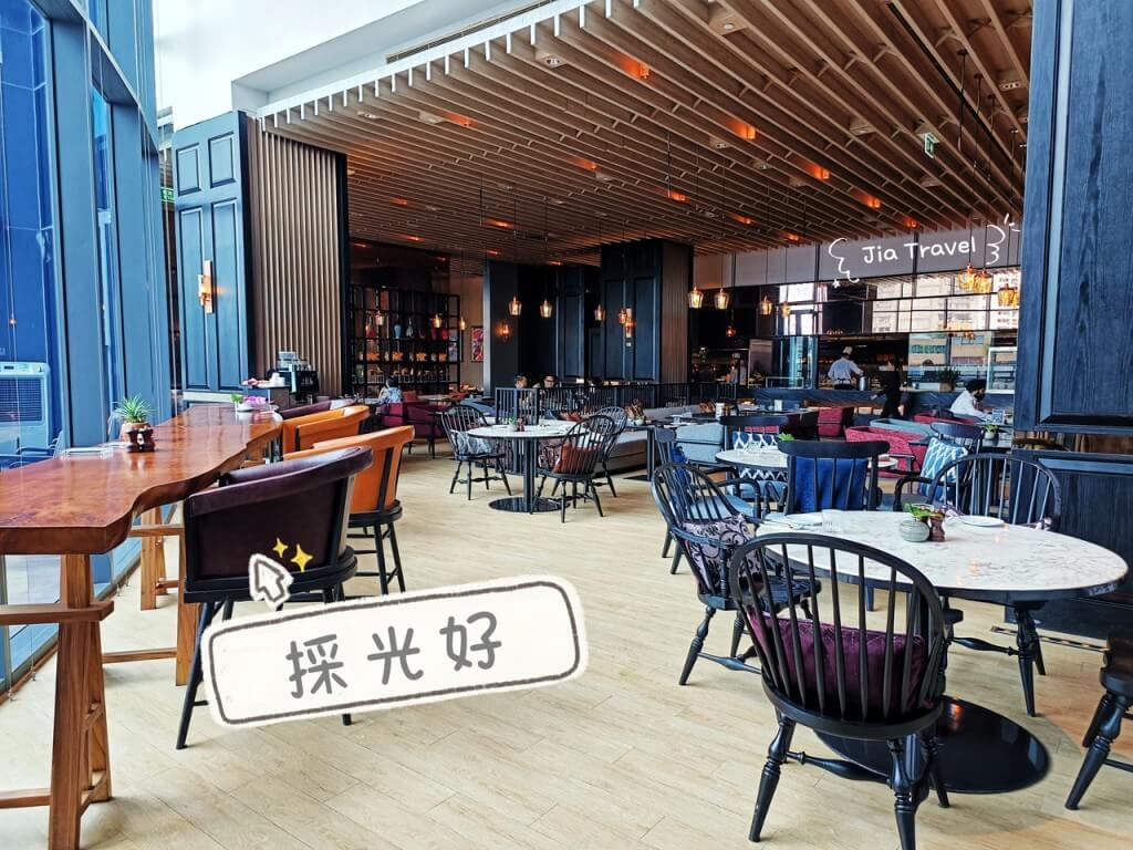 Bright and airy seating area with large windows at Market Cafe Bangkok, perfect for daytime dining.