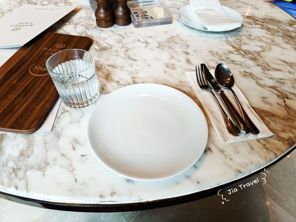 Neat table setting with complimentary water at Market Cafe by Khao. Other drinks are chargeable.