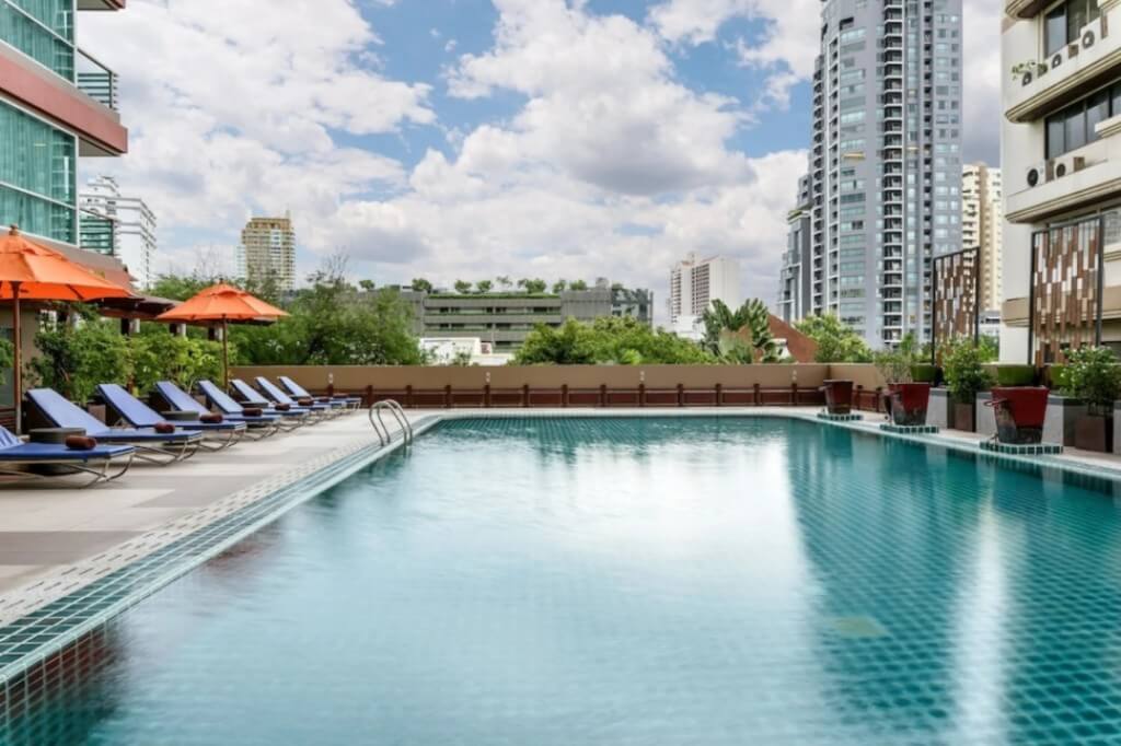 Adelphi Grande Sukhumvit hotel outdoor swimming pool surrounded by lounge chairs for relaxation