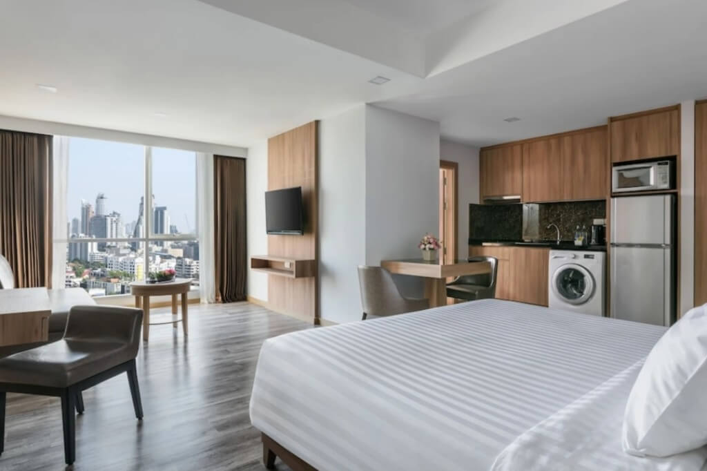 Adelphi Grande Sukhumvit large hotel room with separate living area dining table and kitchen