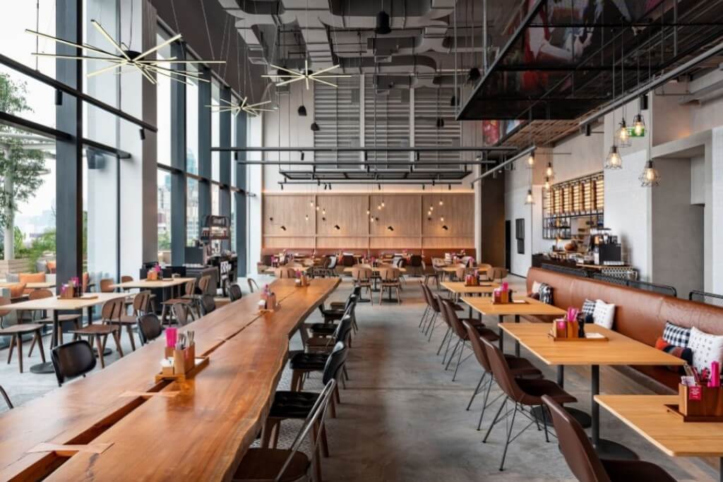 Moxy Bangkok Ratchaprasong breakfast seating area with bright and modern design