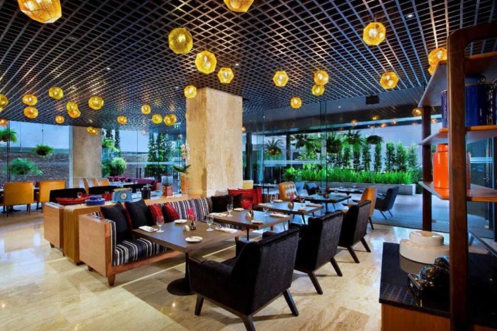 Breakfast seating area at DoubleTree by Hilton Bangkok Sukhumvit is spacious, comfy, and has great lighting.