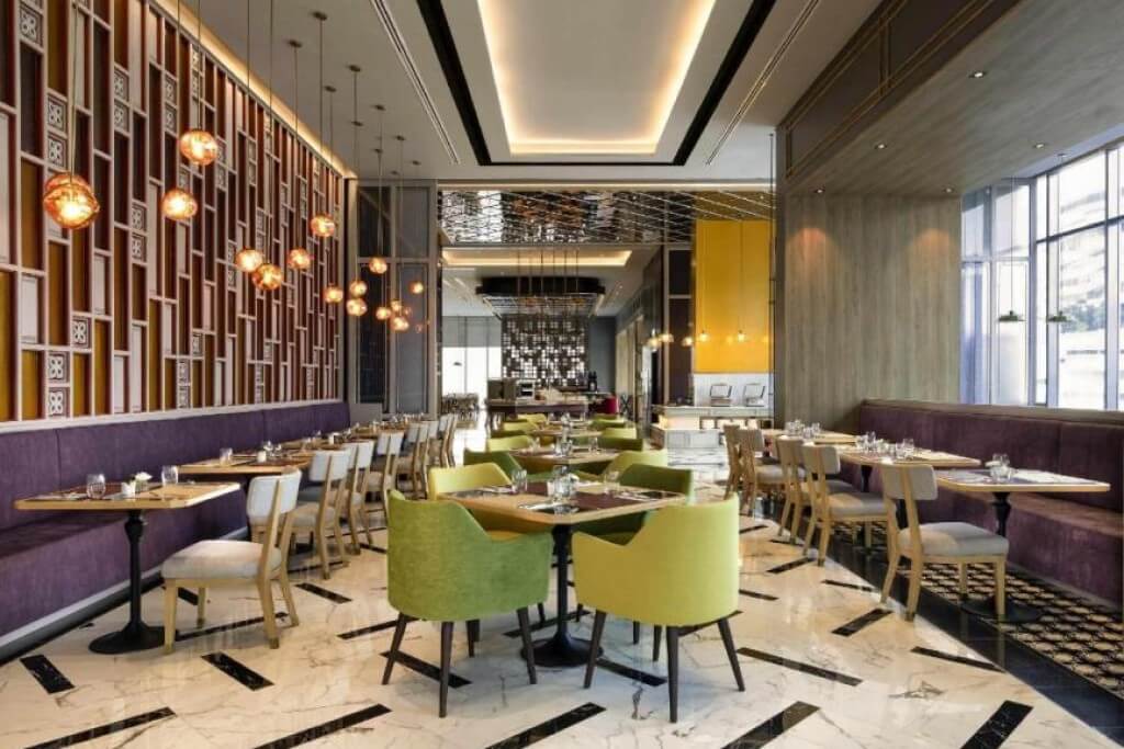 Spacious and bright breakfast restaurant seating area at Mercure Bangkok Sukhumvit 24