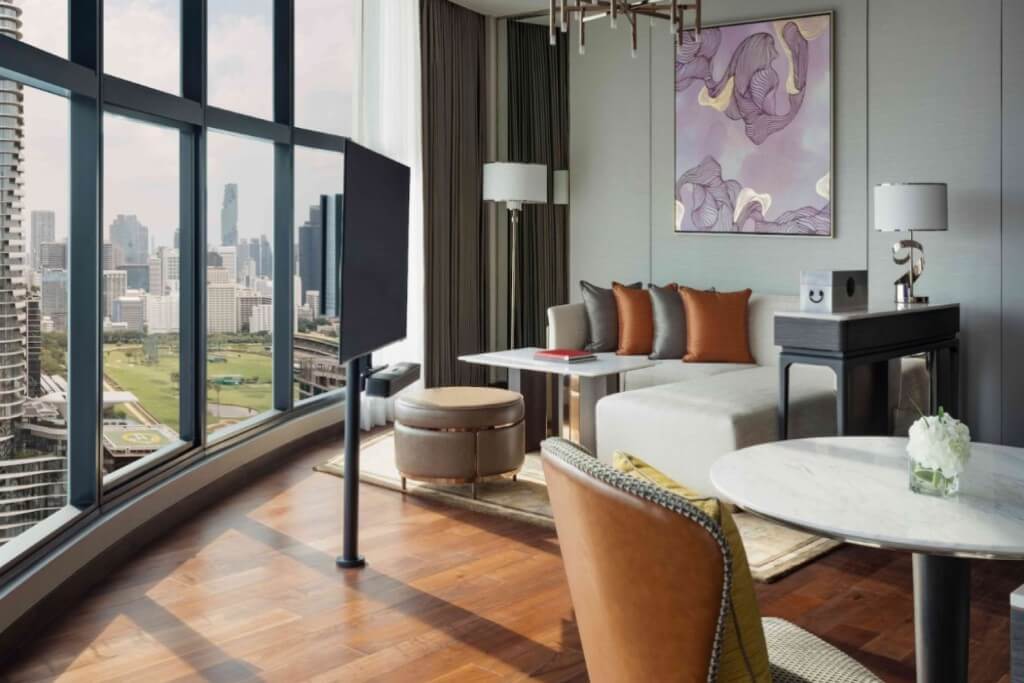 Intercontinental Bangkok suite living room with sofa coffee table TV and separate dining table for comfortable meals