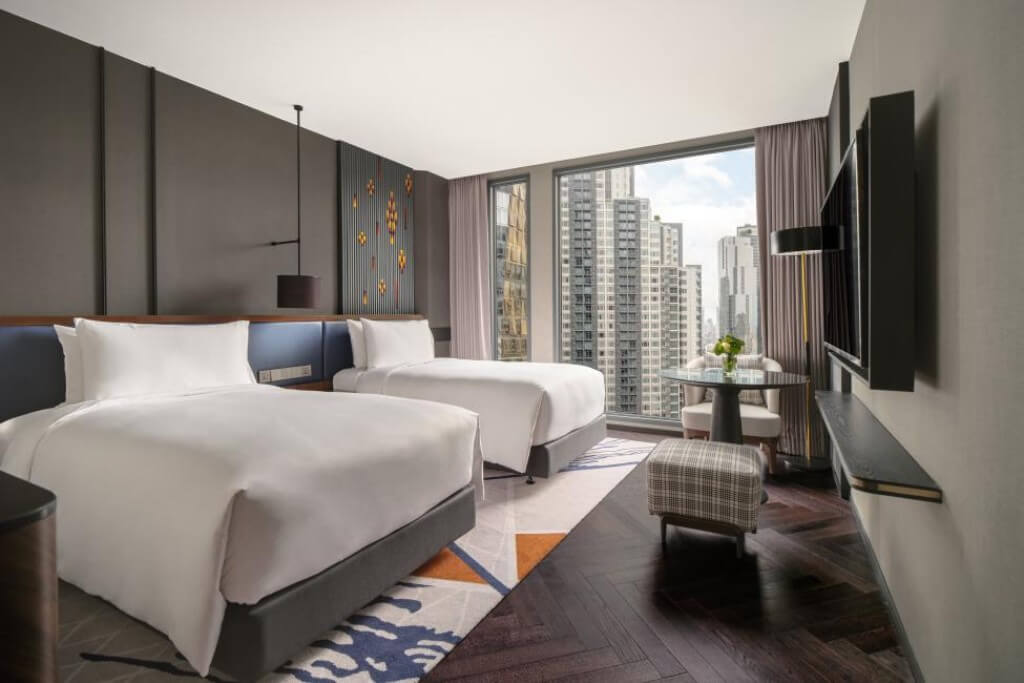 Intercontinental Bangkok spacious king bed room with two large suitcases fully opened and walking space