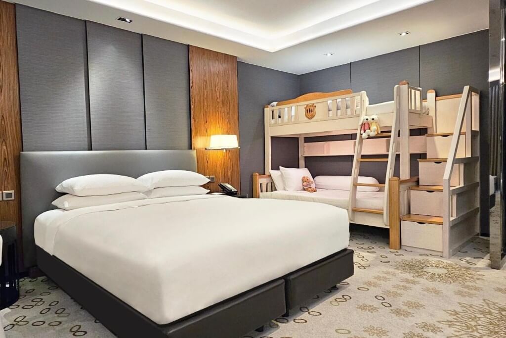 The Hyatt Regency Bangkok Sukhumvit Family Room has bunk beds and a double bed, perfect for a family of four with two adults and two kids.
