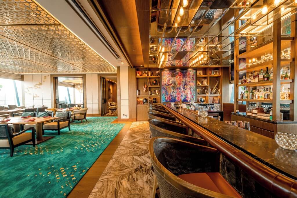 Head to the bar at Hyatt Regency Bangkok Sukhumvit, grab a cocktail, and enjoy the sunset and the city lights coming on in Bangkok—such a great vibe.