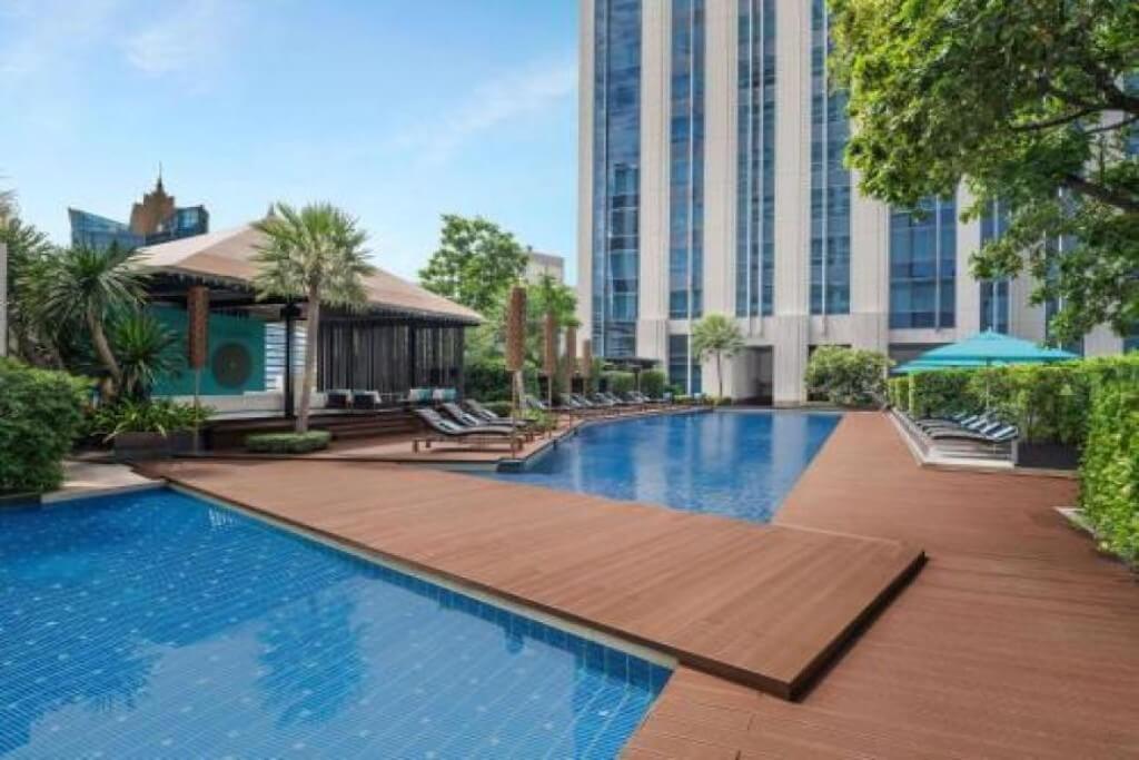 Sofitel Bangkok Sukhumvit rooftop pool with sun loungers and city view