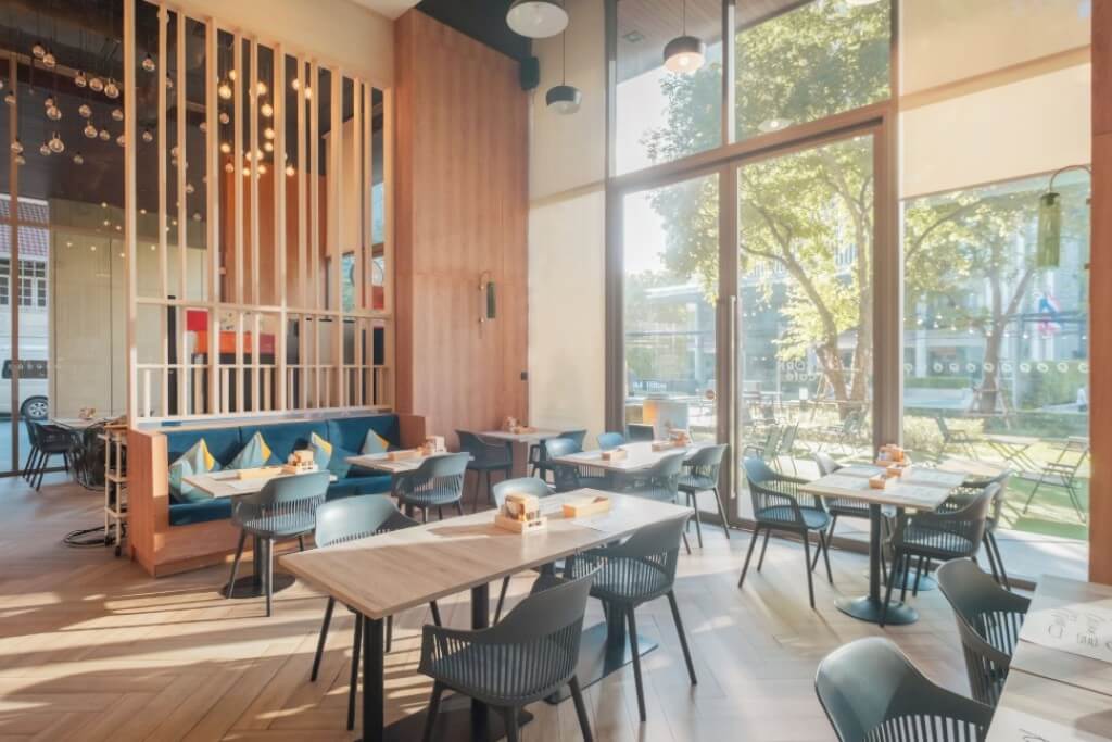 Oakwood Suites Bangkok breakfast restaurant with bright and airy wooden decor