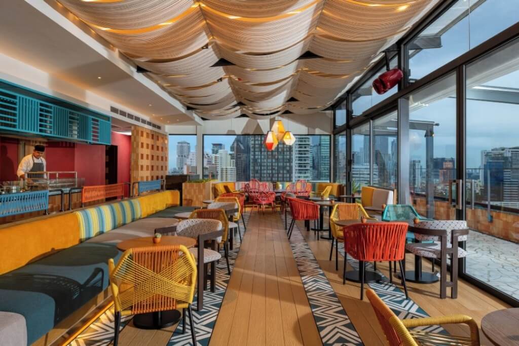Tribe Living Bangkok Sukhumvit 39 breakfast restaurant with spacious seating and vibrant, bold color design