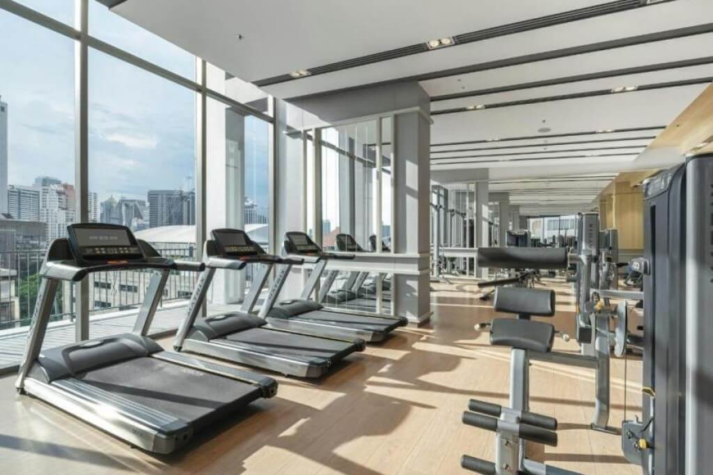 Oakwood Suites Bangkok gym with full range of fitness equipment and bright lighting