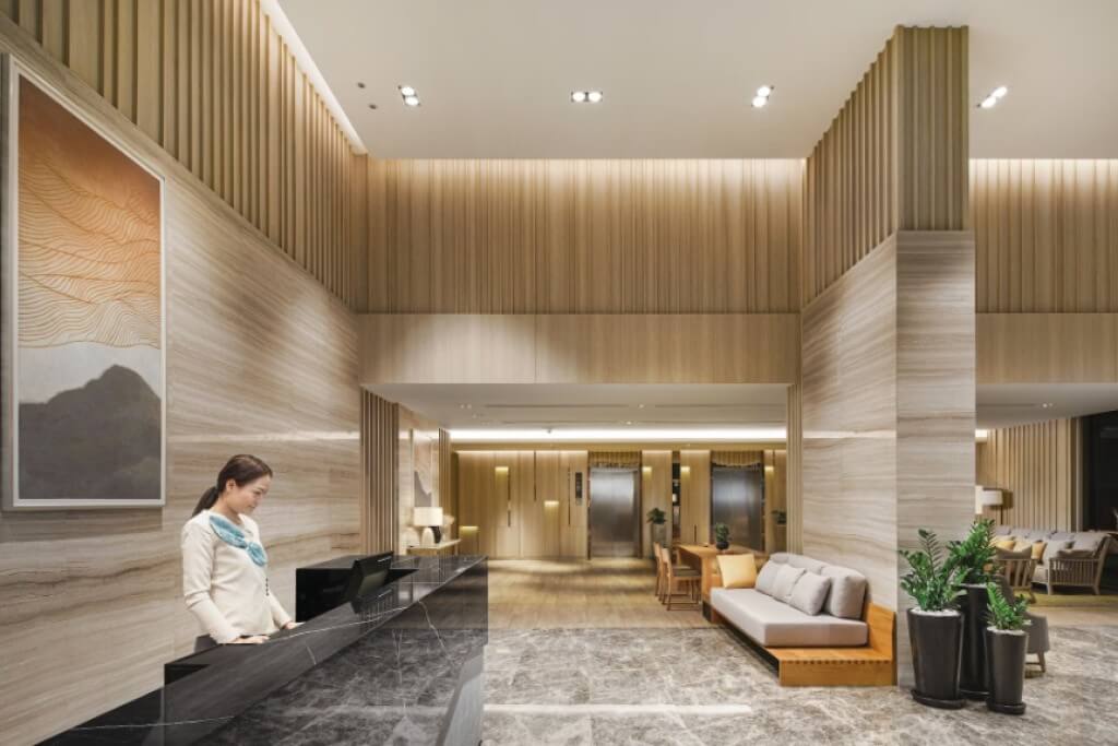 Oakwood Suites Bangkok lobby reception desk with friendly staff