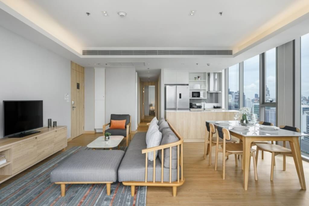 When you first walk into a room at Oakwood Suites Bangkok, the first thing you'll notice is the massive living room, dining table, and full kitchen setup.