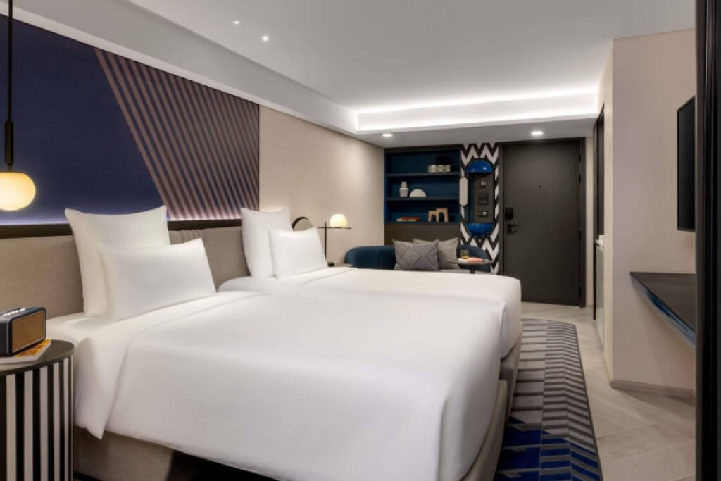 Tribe Living Bangkok Sukhumvit 39 twin bed room interior with modern and vibrant design