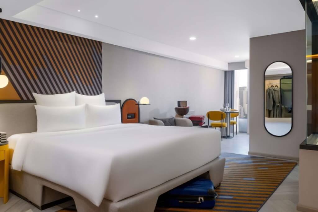 Tribe Living Bangkok Sukhumvit 39 double bed room with comfortable bedding and city view