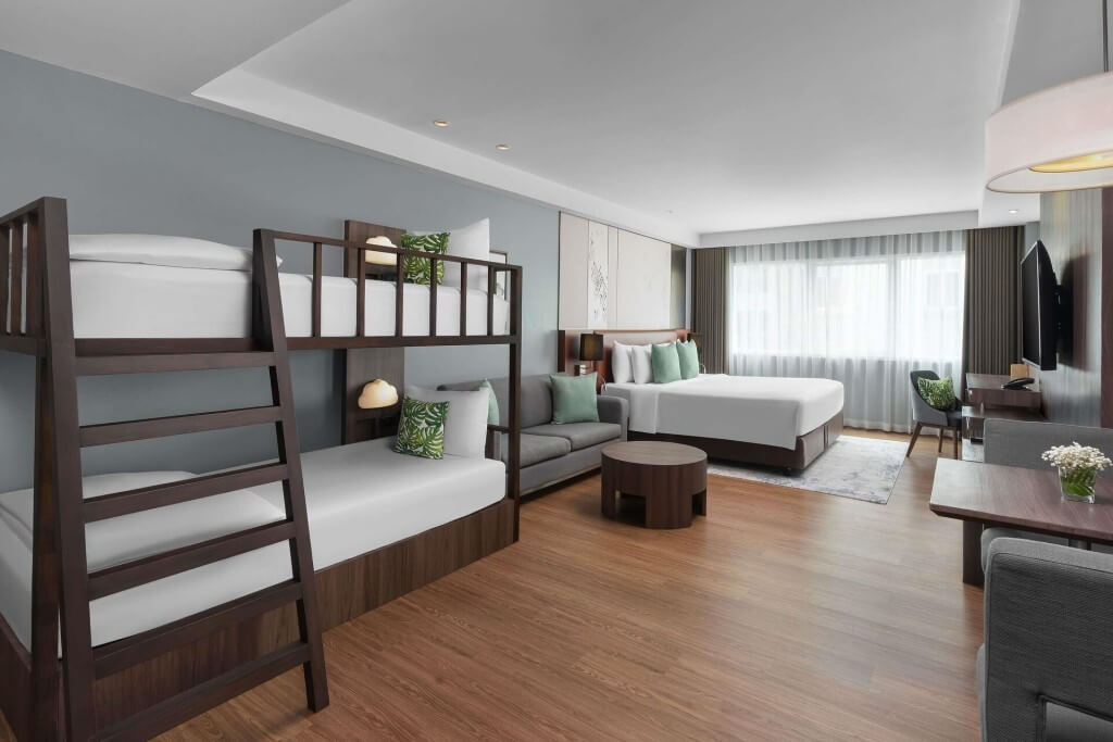 Family room with double bed and bunk beds at Novotel Living Legacy Bangkok
