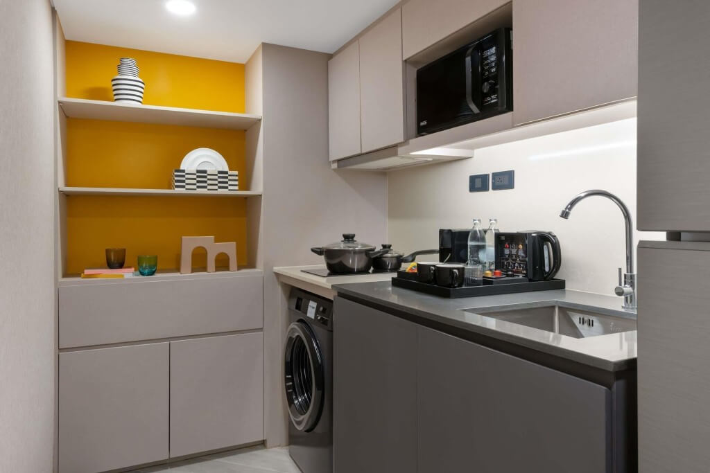 Tribe Living Bangkok Sukhumvit 39 kitchenette with microwave, fridge, and coffee maker
