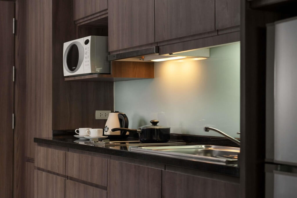 Kitchenette with microwave at Novotel Living Legacy Bangkok