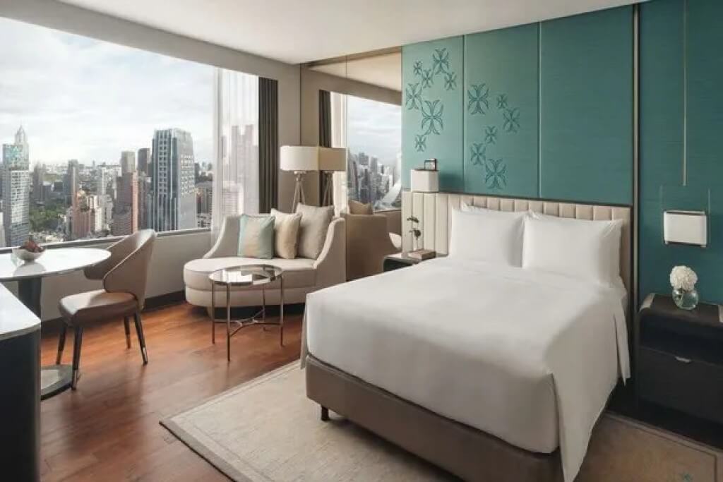 InterContinental Bangkok Double Room with a double bed, chaise lounge, seating area, and large windows with city views.