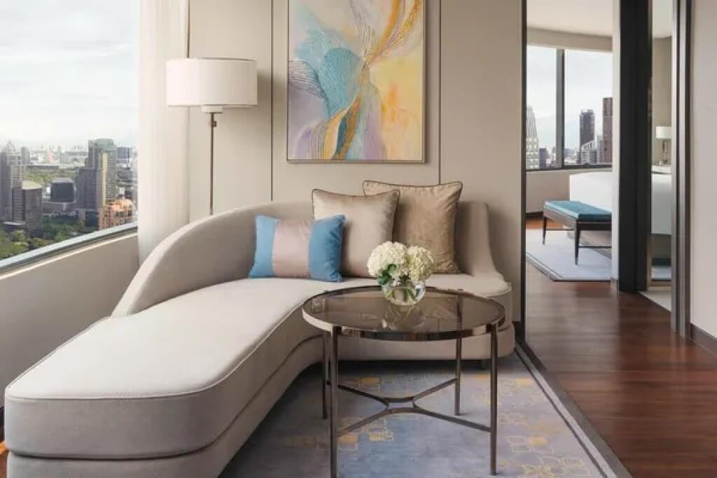 Living room in the Two-Bedroom Suite at InterContinental Bangkok, featuring a large L-shaped sofa.