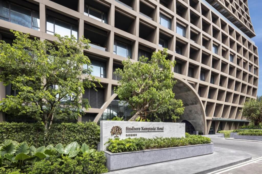 Sindhorn Kempinski Hotel Bangkok modern luxury exterior building on Langsuan road with green surroundings