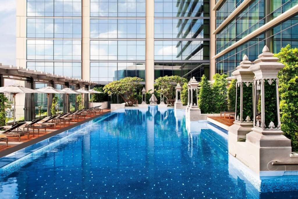 beautiful and tranquil swimming pool at The St. Regis Bangkok with elegant loungers