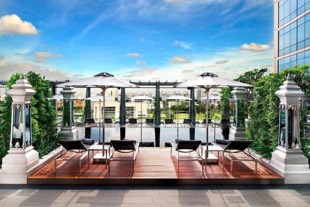 relaxing poolside lounge area at The St. Regis Bangkok with resort-style atmosphere