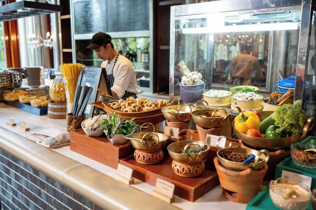 Hotel Indigo Bangkok Wireless Road live cooking station serving traditional Thai noodle soup for breakfast