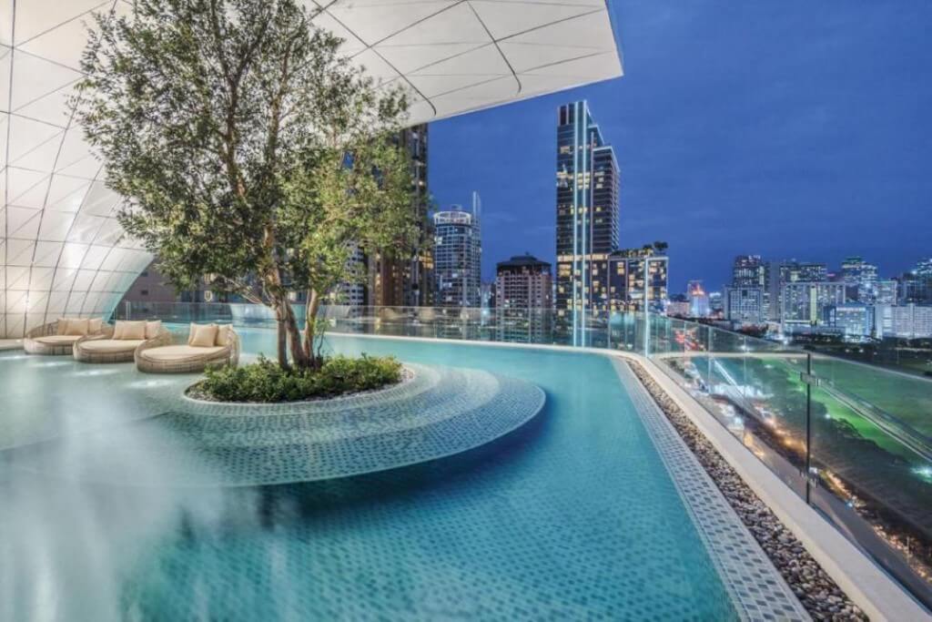 Beautiful night view of Bangkok city lights from rooftop swimming pool at Waldorf Astoria Bangkok