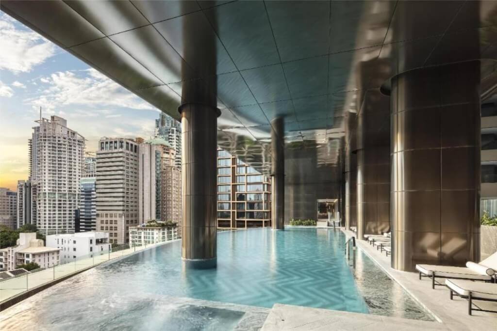 Open air swimming pool at Sindhorn Kempinski Hotel Bangkok with city view