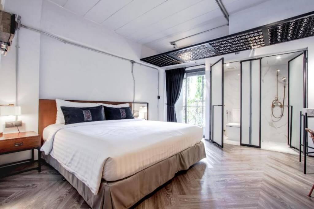 Bright IR ON Hotel guest room with floor-to-ceiling window and natural sunlight