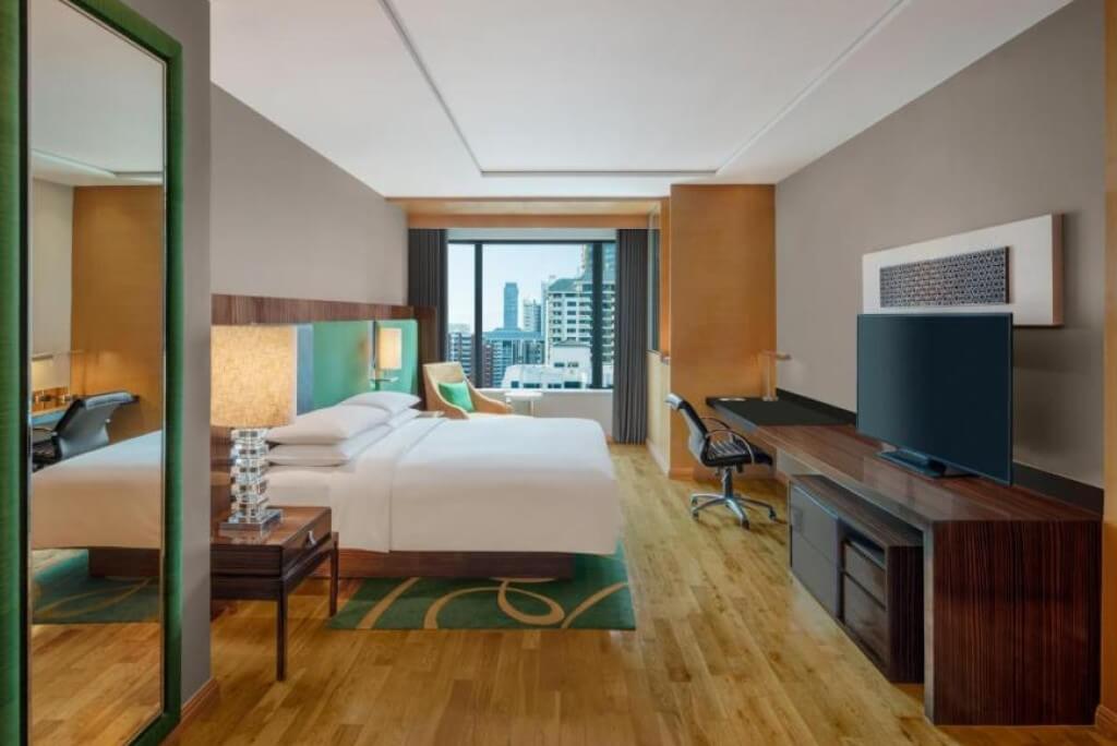 Spacious king bed room at Renaissance Bangkok Ratchaprasong Hotel with separate seating area