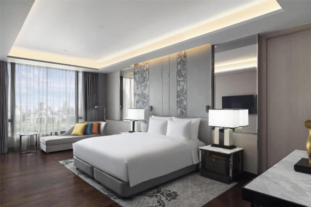 Spacious king bed room at Sindhorn Kempinski Hotel Bangkok with comfortable bedding