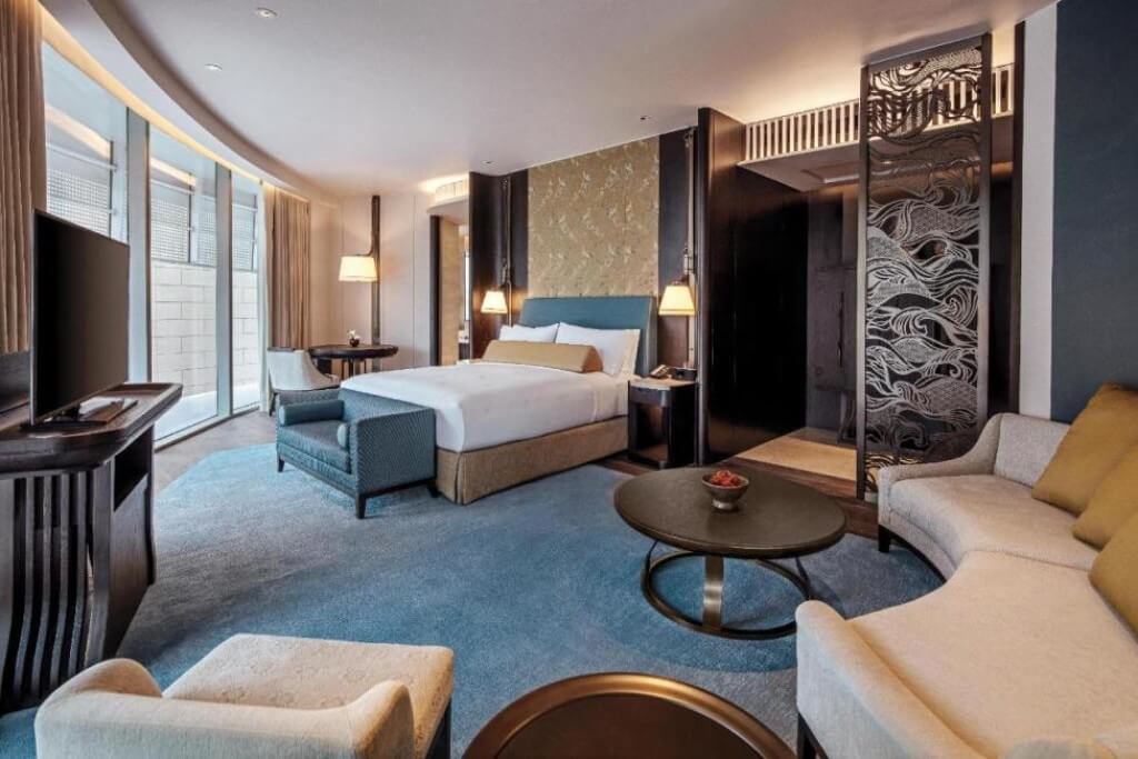 Spacious king deluxe room with large comfortable sofa at Waldorf Astoria Bangkok