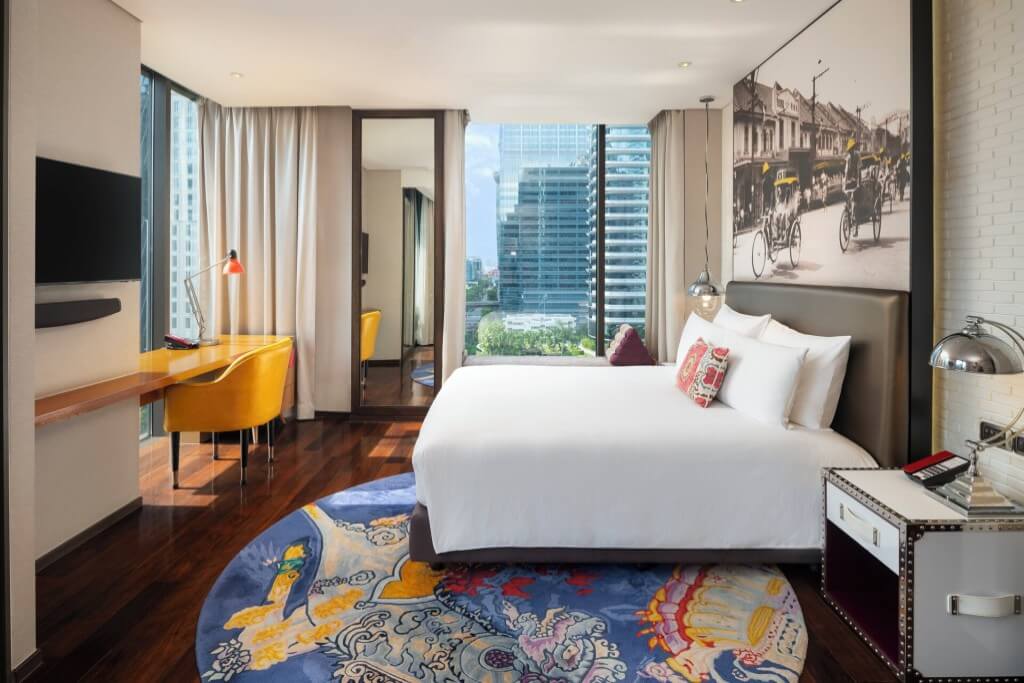 Hotel Indigo Bangkok Wireless Road guest room with retro industrial design vintage radio and artwork