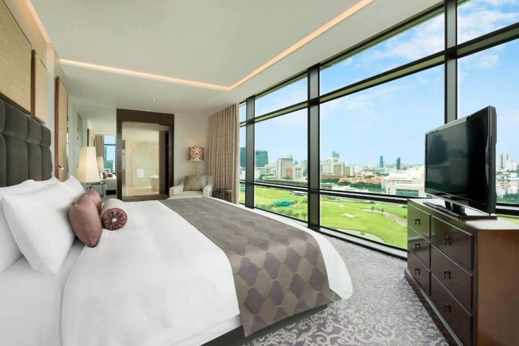 bright king bedroom with floor-to-ceiling windows and elegant decor at The St. Regis Bangkok
