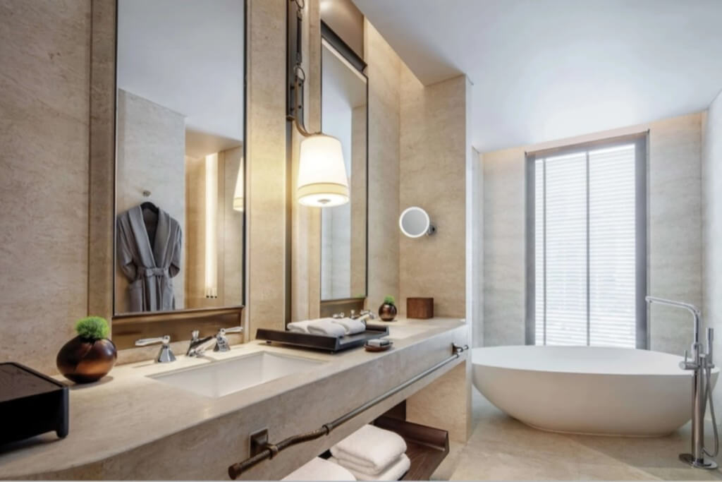 Large and luxurious bathroom with separate bathtub and walk-in shower at Waldorf Astoria Bangkok