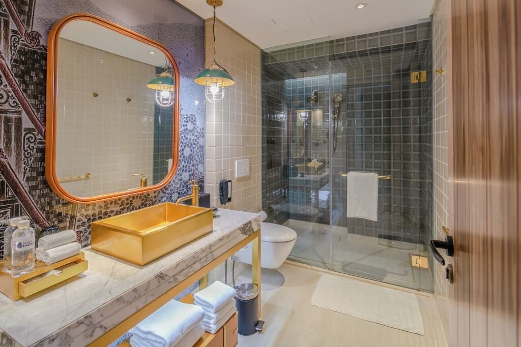 Hotel Indigo Bangkok Wireless Road spacious bathroom with walk-in shower and separate toilet area
