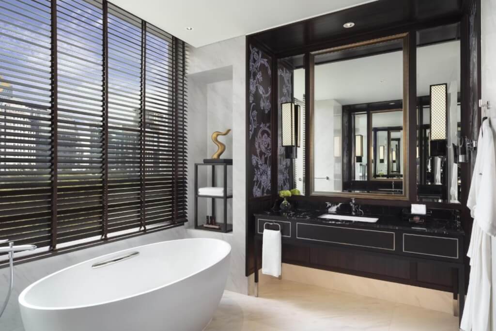 Spacious bathroom with large bathtub at Sindhorn Kempinski Hotel Bangkok