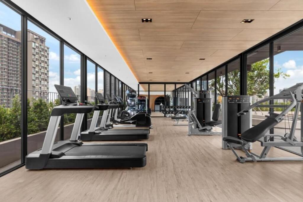 Madi Paidi Bangkok Autograph Collection fitness center with floor-to-ceiling windows and natural light