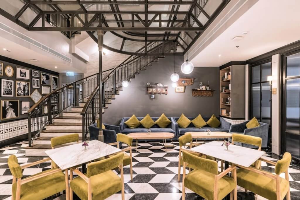 The Salil Hotel Sukhumvit 57 lobby with comfortable lounge chairs and grand rotating staircase for photos
