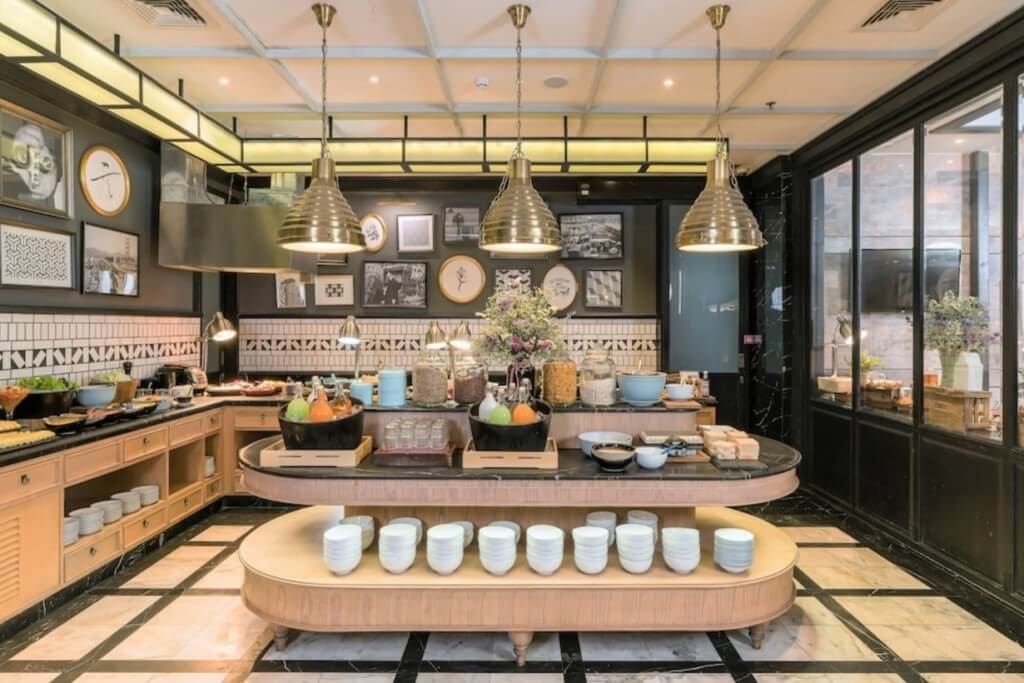 The Salil Hotel Sukhumvit 57 breakfast buffet with wooden tones and Morandi color tableware