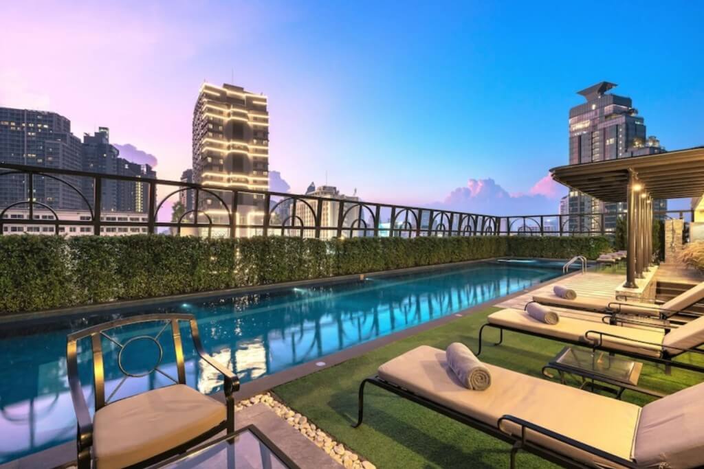 The Salil Hotel Sukhumvit 57 rooftop pool with magical castle design and stylish lounge chairs