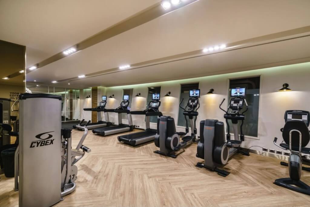 Gym treadmill with personal TV at MUU Bangkok Hotel