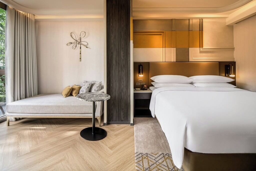 Madi Paidi Bangkok Autograph Collection guest room with floor-to-ceiling windows and natural light