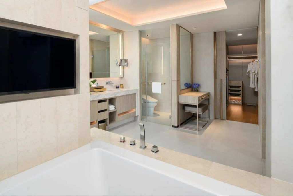 Spacious bathroom with bathtub and built-in TV at Hotel Nikko Bangkok