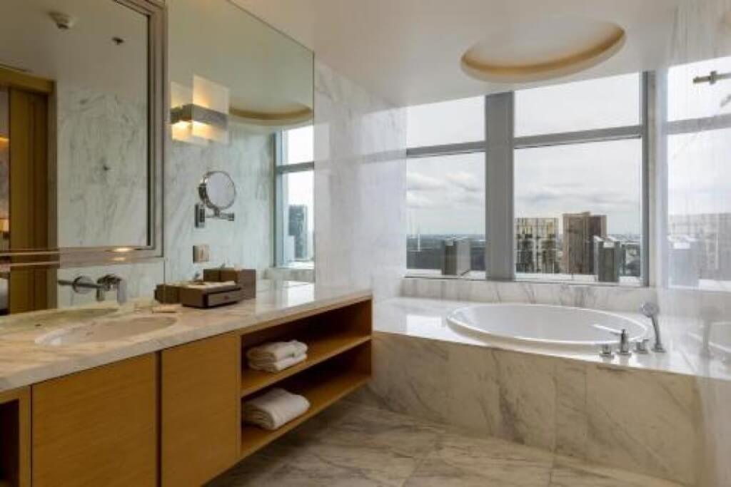 Bangkok Marriott Hotel Sukhumvit bathroom with separate bathtub and walk-in shower