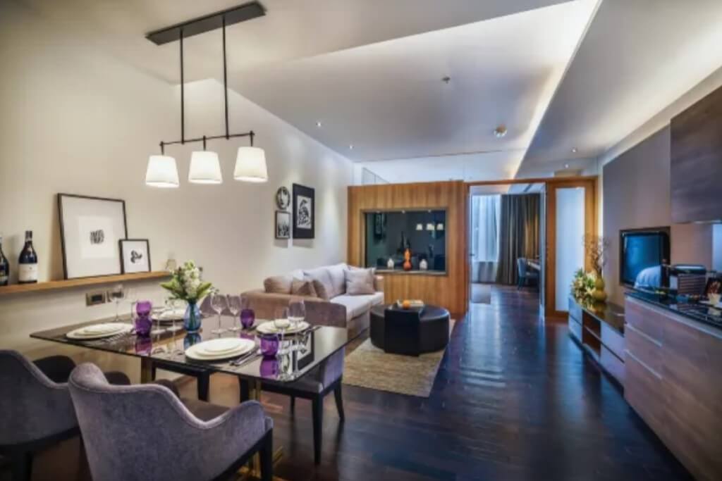 Spacious suite living room and dining area at MUU Bangkok Hotel