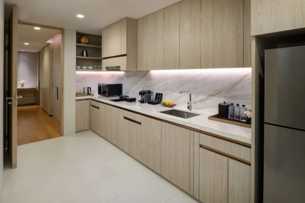 Full kitchen with coffee machine microwave and large refrigerator in suite at Hotel Nikko Bangkok